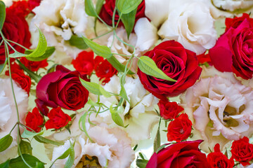 Arrangement of red roses and white lisianthus