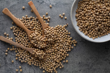 Soybean raw food nutrition in wooden spoon on a pile