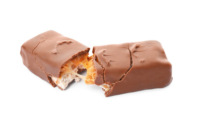 Broken chocolate bar with caramel, nuts and nougat isolated on white