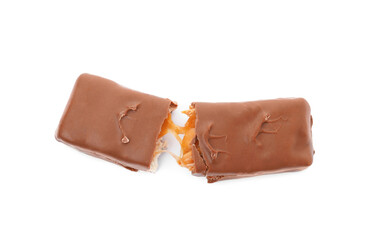 Broken chocolate bar with caramel, nuts and nougat isolated on white, top view