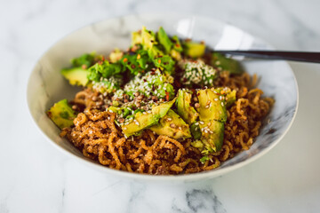 vegan garlic and ginger noodles with avocado and fried onions, healthy plant-based food