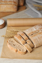 Fresh crispy ciabatta on white wooden table