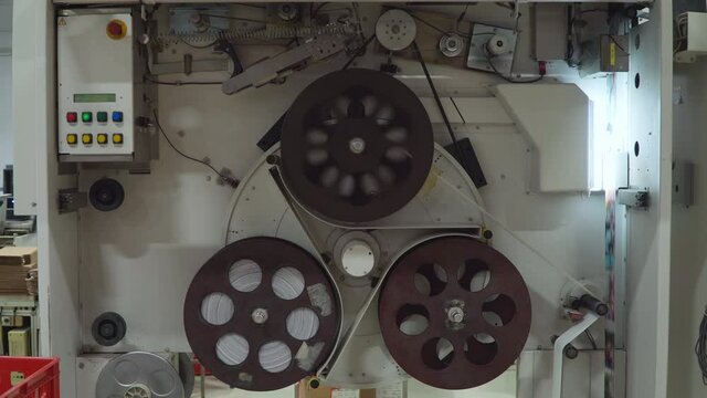 Reel for printing photos on the babin. Industrial photo printing in a factory for books and newspapers. Workshop of the printing house.