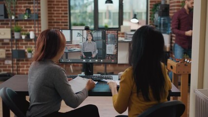 Team of asian women meeting with candidate on video conference call to attend online job interview. Business people using remote videoconference to discuss employment with applicant.