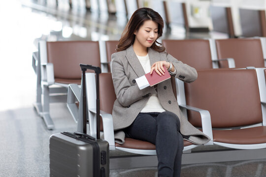 Young woman waiting for flight at the airport