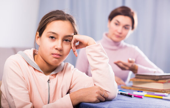Young mother seriously talks to daughter about bad progress at school