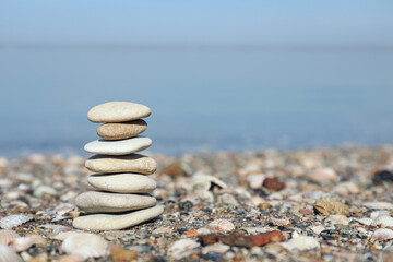 Fototapeta na wymiar Stack of stones on beach, space for text. Harmony and balance concept