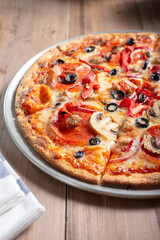 A view of a supreme style flatbread pizza.
