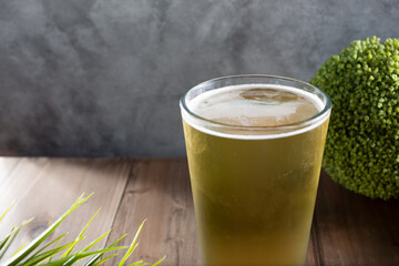 A view of a light colored beer in a glass.
