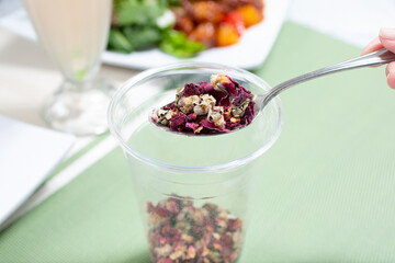 A view of a spoonful of dried rose hips.