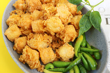 fried tofu on plate and yellow background