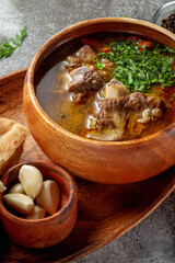 Beef goulage with garlic and pita bread on a gray stone table, Flatlay