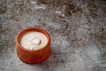 Cream sauce in a sauce pot on a restaurant stone table