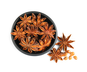 Fototapeta premium Bowl and dry anise stars on white background, top view