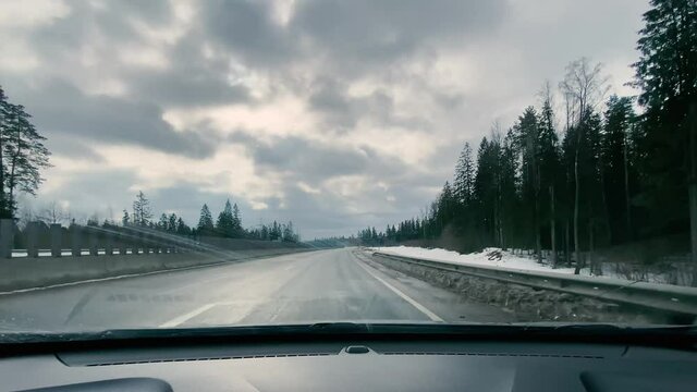 driving in a car along the highway to the port of Ust-Luga on a spring day