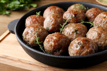 Tasty cooked meatballs served on wooden board, closeup - obrazy, fototapety, plakaty