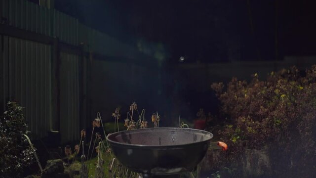 Beautiful smoke comes from the barbecue maker. Evening dinner in nature. Country cooking method. A place for a barbecue.