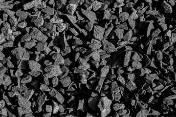 Coal. Combustible sedimentary rocks are brown to black in color. Caused by the accumulation of natural plant remains.