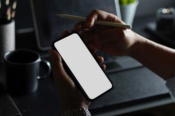 A man's hands holding smartphone blank screen mockup
