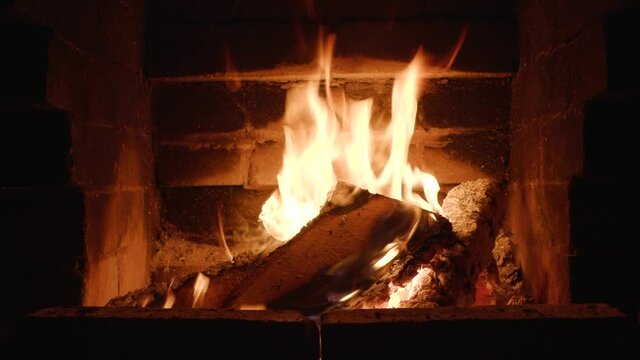 burning firewood in a home fireplace close-up