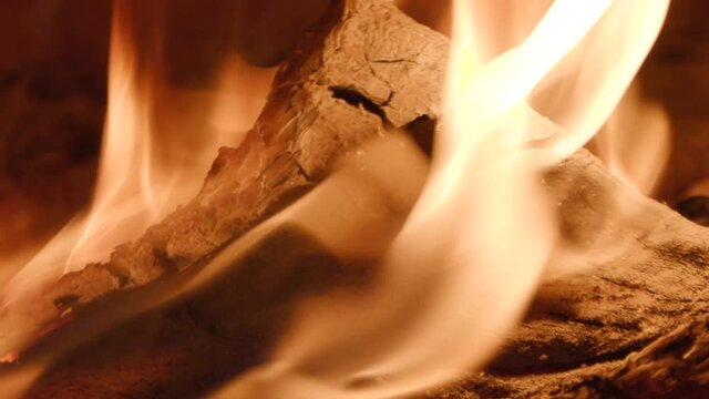 burning firewood in a home fireplace close-up