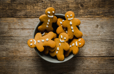 Stack of gingerbread cookies in the bowl on the wooden table. Christmas background. Shot from above.