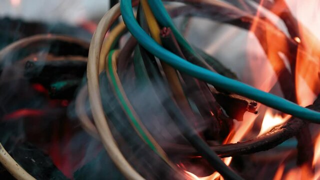 wires on fire. Firing winding insulation of electrical wiring in the fire in the winter woods