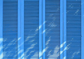 Texture of vintage blue door. Background of classic louver with horizontal wooden pattern.