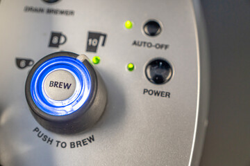 Coffee machine brew button in office tea room