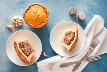 Tasty beef pot pies on color background