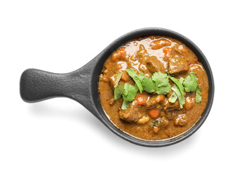 Frying pan with tasty beef curry on white background