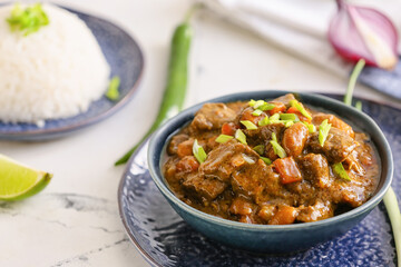 Plate with tasty beef curry on table