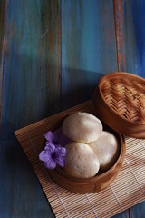 steamed bun named bao zi or bapao in a patterned plate 