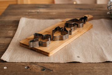 molds for baking cookies lie on a wooden board