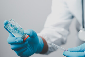 A doctor or scientist in the COVID-19 medical vaccine research and development laboratory holds a...