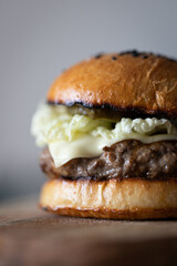 Homemade burgers with beef and cheese, homemade buns. Front view.