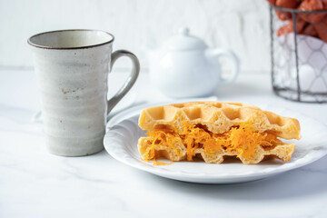Thai foi thong waffles in white plate and coffee mug snack concept
