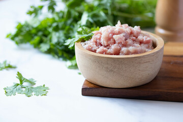 Ground raw pork in a wooden cup