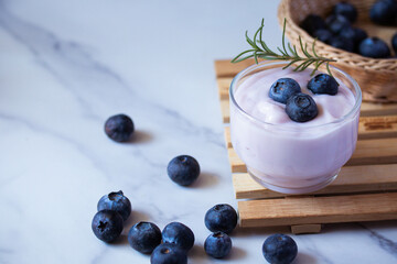 Fresh blueberry yogurt in a clear glass