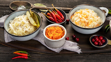 Pickled vegetables on wooden background. Salting vegetables.