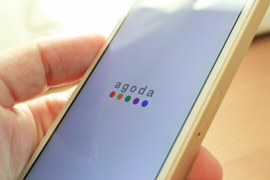 TOKYO, JAPAN. 2018 Feb 2nd. Close up the Hand and agoda Logo on Smartphone Display.