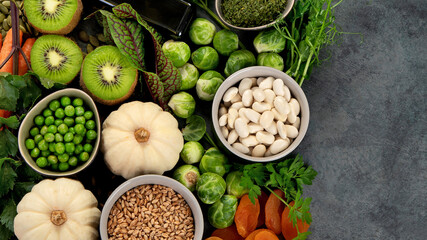 Foods high in vitamin K on dark background.