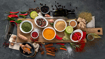 Assortment of spices on gray background.