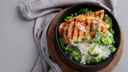 Grilled chicken with green vegetables and rice.