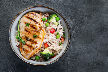 Grilled chicken with vegetables and rice.
