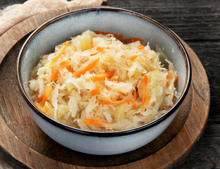 Sauerkraut on wooden background.