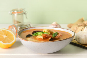 Bowl of spicy Thai soup on table