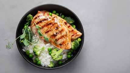 Grilled chicken with green vegetables and rice.