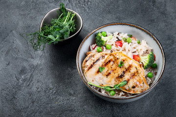 Grilled chicken with vegetables and rice.