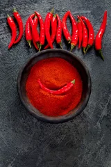 Fotobehang Red chili or chilli cayenne pepper on dark background. © bit24